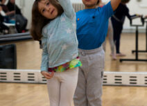 Two children stretching in ballet poses